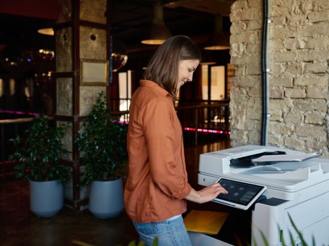 woman using a managed print device