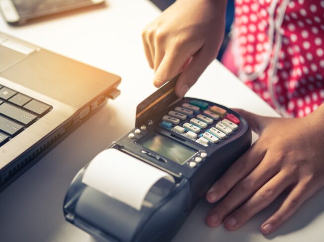 person using a credit card POS machine